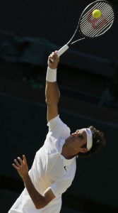 Roger Federer of Switzerland serves to Novak Djokovic of Serbia during their men's singles final match at the All England Lawn Tennis Championships in Wimbledon, London, Sunday, July 6, 2014. (AP Photo/Pavel Golovkin)